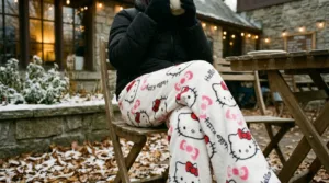 Girl outside with a new style of the white hello kitty pants while drinking coffee